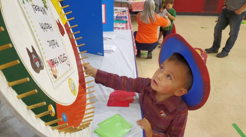 Jonas William, 3, spins the wheel at the audiology table during the 3 Year Old Round Up Saturday, Sept. 24 in Williams Lake. (Monica Lamb-Yorski photo - Williams Lake Tribune)